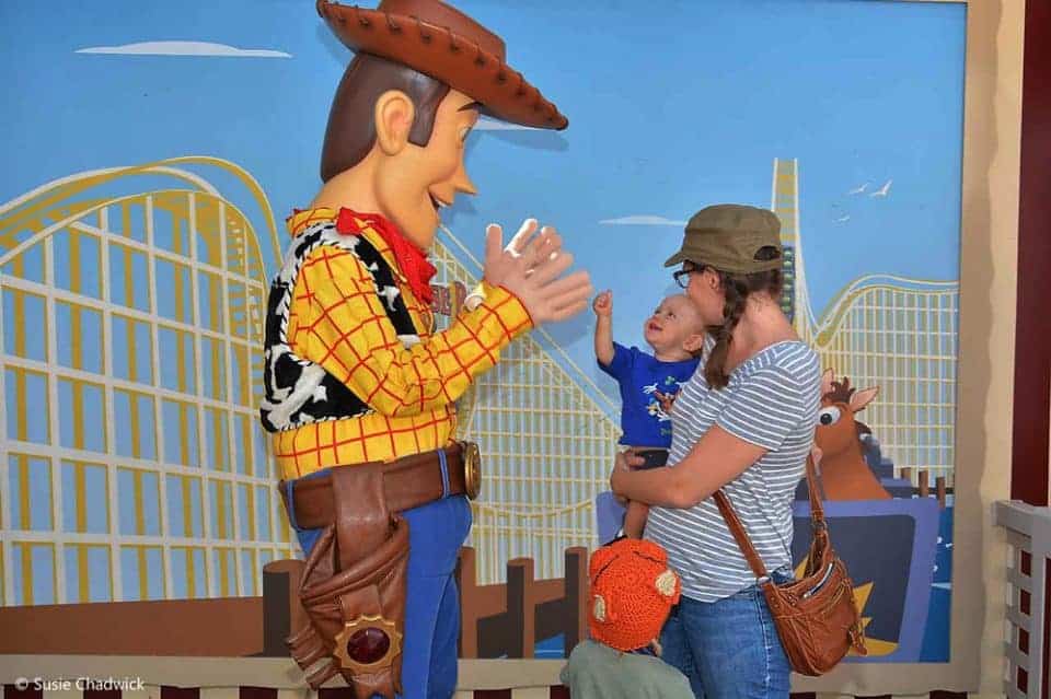 Mom and baby meeting Woody at Disneyland.