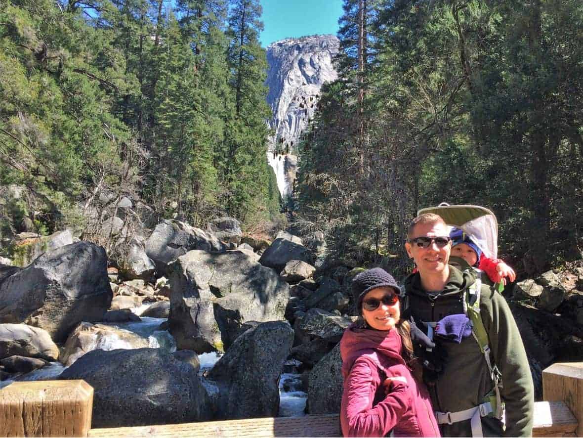 Dad with toddler in a hiking carrier and mom at Yosemite National Park: National Parks with kids
