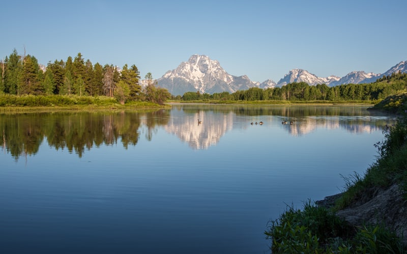 Grand Teton mountains reflected in the water of the Snake River