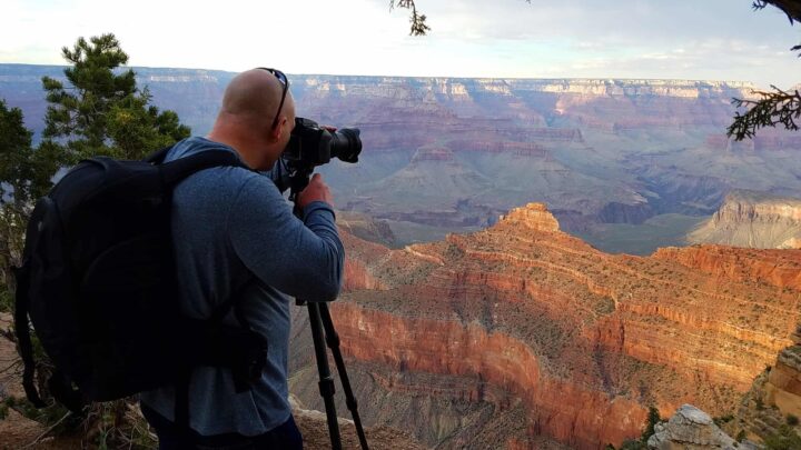 photography gear for hiking: photographer at the Grand Canyon