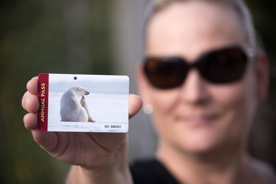 woman holding a US National Park Pass