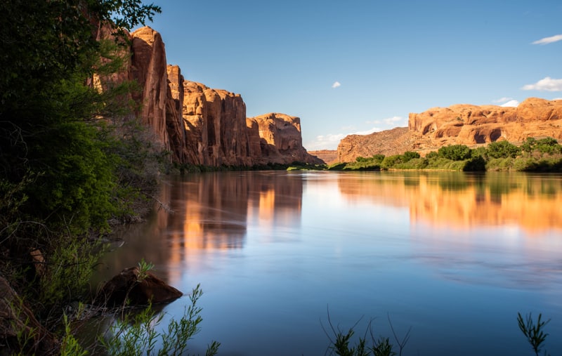 Colorado River in Moab with glowing red rock reflections