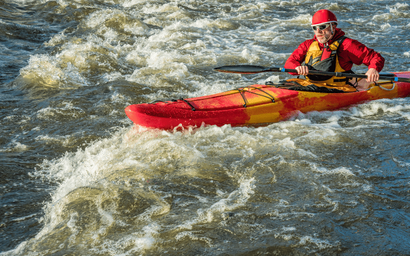 man kayaking a river