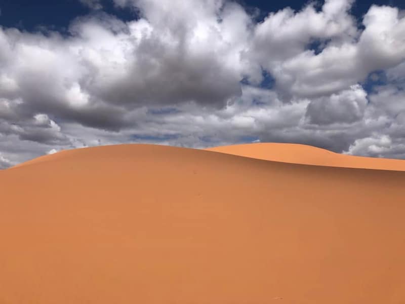 negative space sand dune with cloudy sky