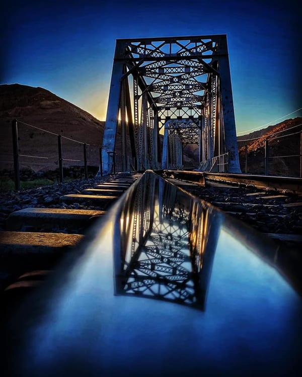 bridge reflection on a rail road track beam