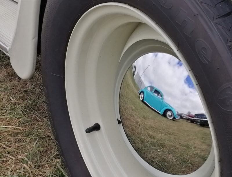 reflection of a car on a tire rim
