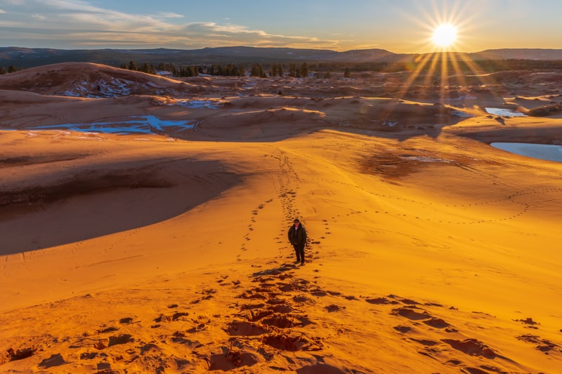 woman at Coral Pink Sand Dunes at sunset