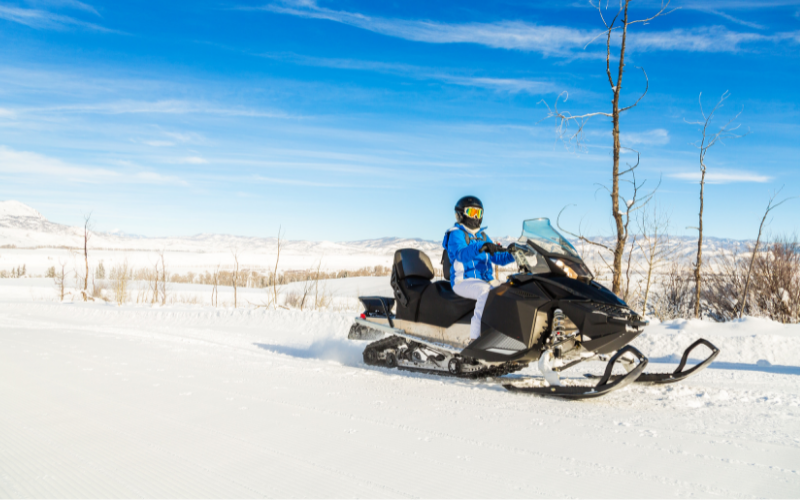 woman on a snowmobile in the winter