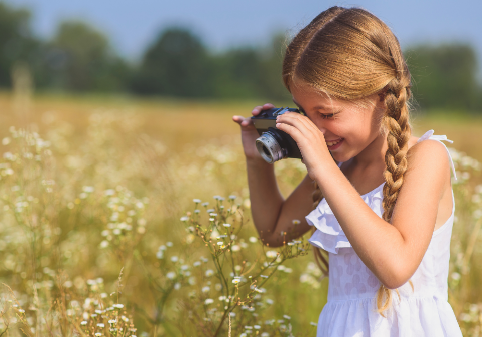 girl taking pictures of flowers