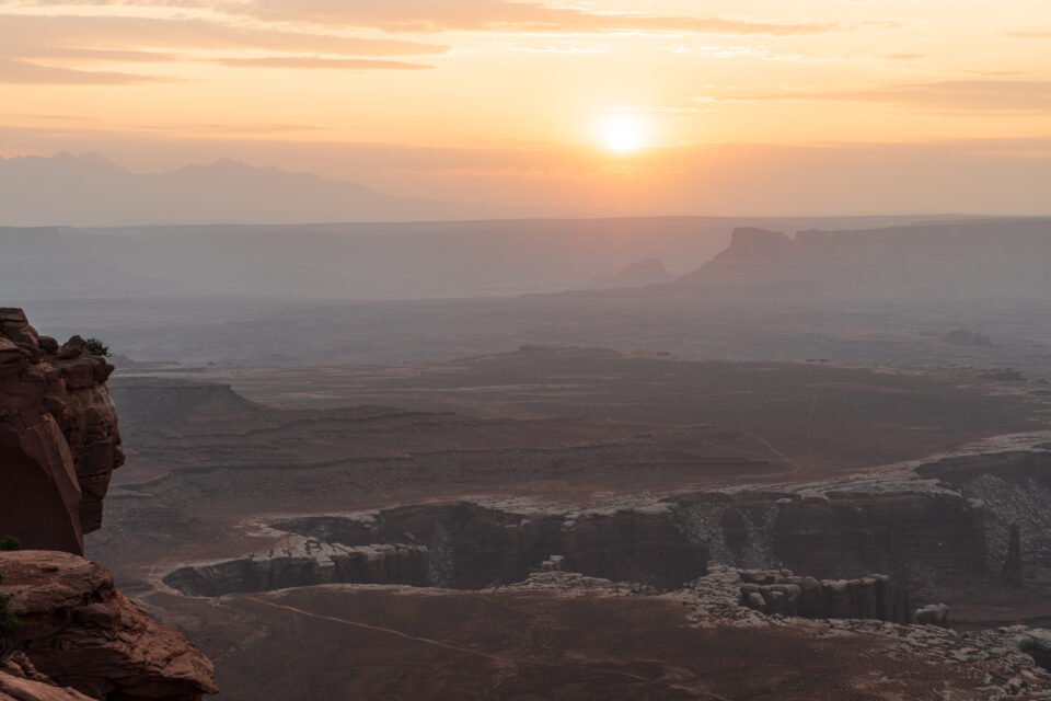 hazy sunrise at Grand View Point Canyonlands