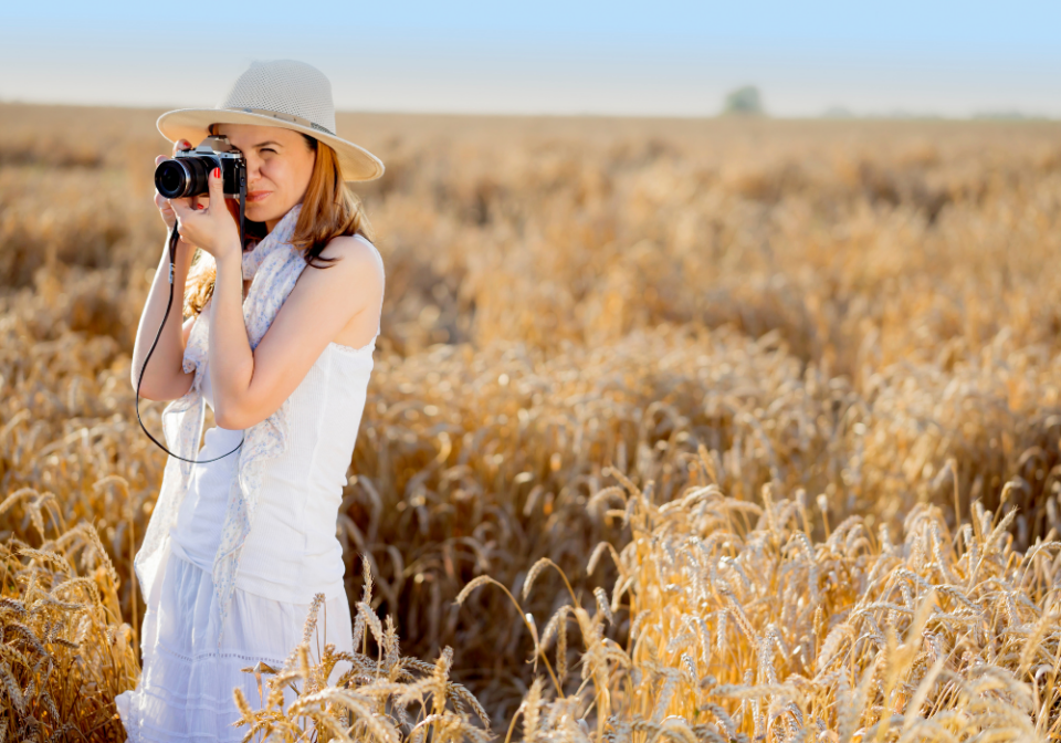 woman taking pictures in a field
