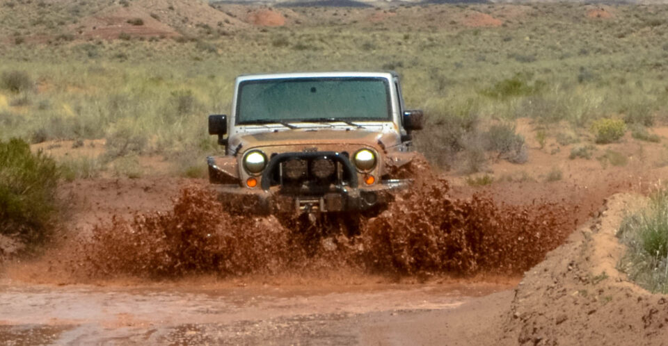 Jeep driving muddy road in Cathedral Valley