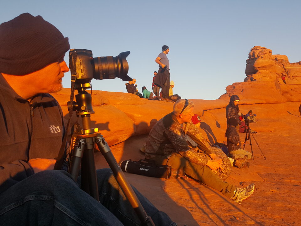 photographer at Delicate Arch at sunset