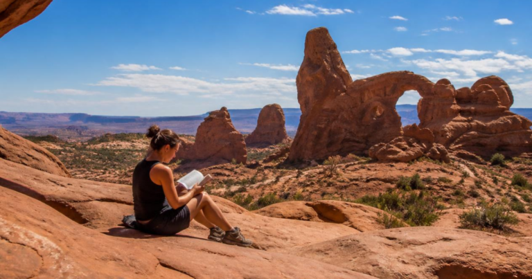 Reading a book in Arches National Park